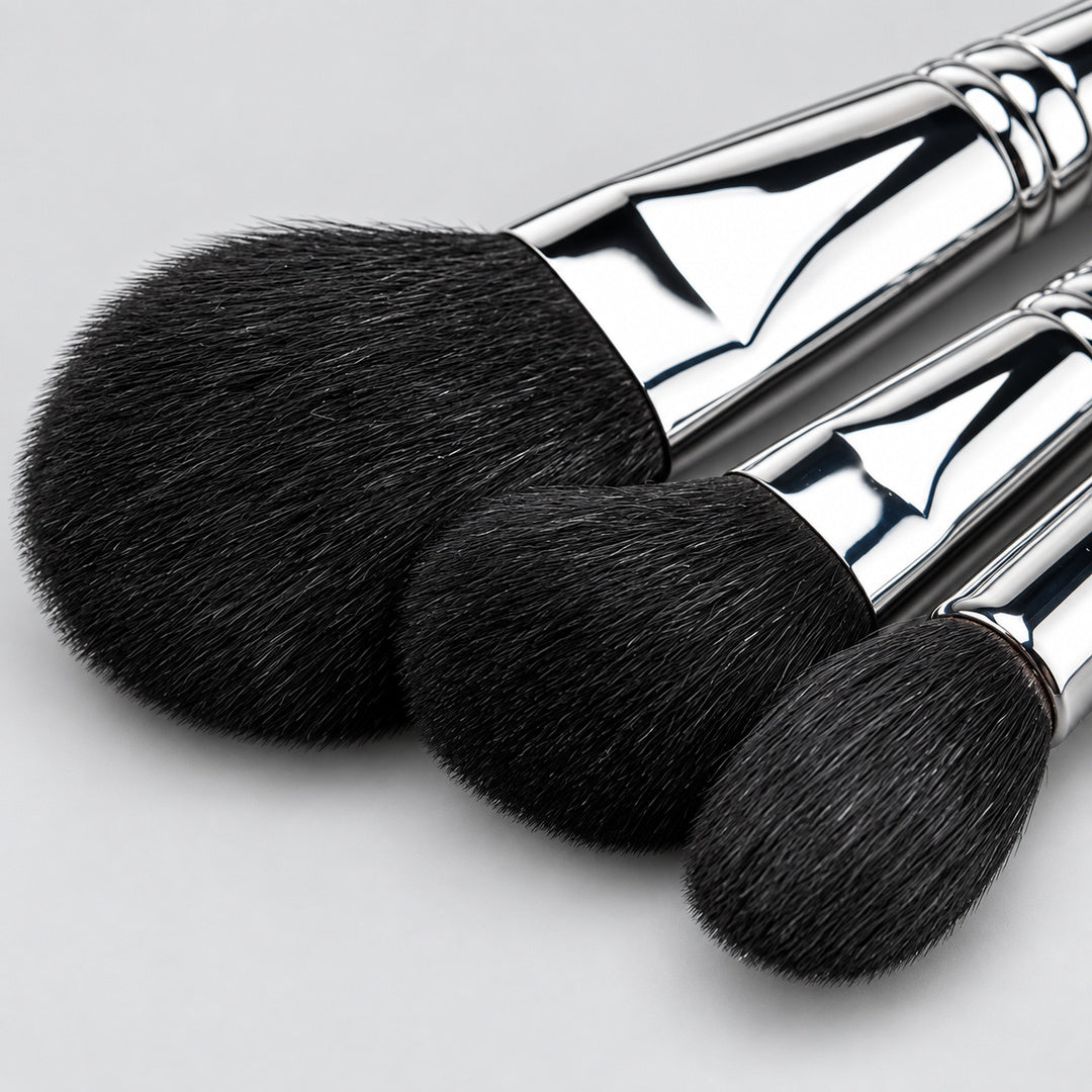 Detaliu pensule profesionale Silver Touch pentru pudră, blush și iluminator, cu forme rotunjite, fire negre și finisaj argintiu.